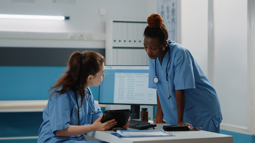 Nurses discussing and looking at a tablet